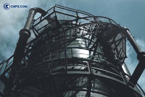 Spiral staircase on an industrial tower with pipes