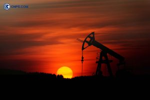 Silhouette of an oil pump jack at sunset